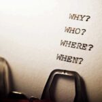 Typewriter with questions typed on paper