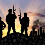 Three armed silhouettes with city skyline at sunrise