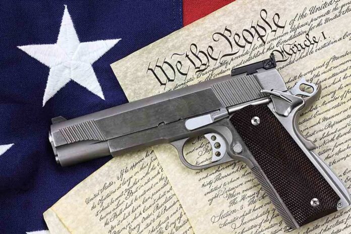 129482747 featured image Gun on U.S. Constitution and flag.