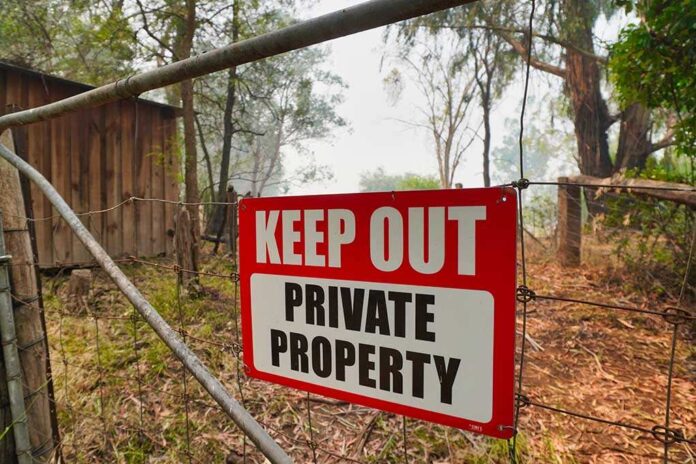 1605784459 featured image Red Keep Out Private Property sign on gate