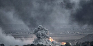 Smoke and fire rise from explosion in city landscape