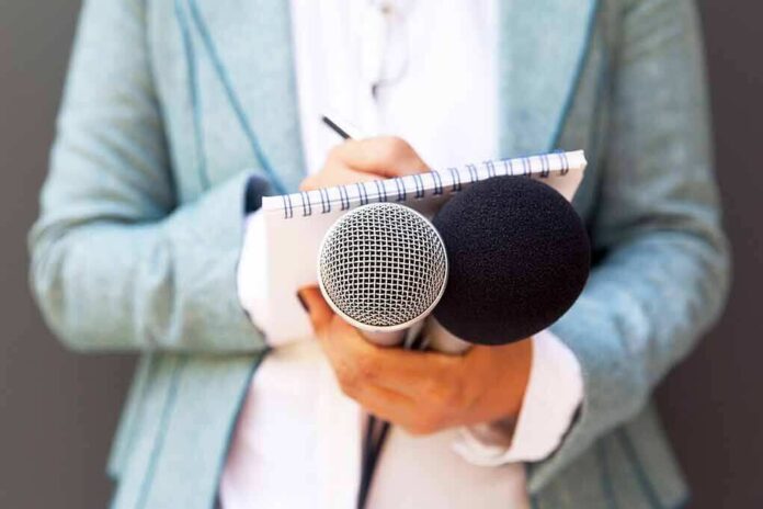 1189499641 featured image Person holding microphones and a notepad