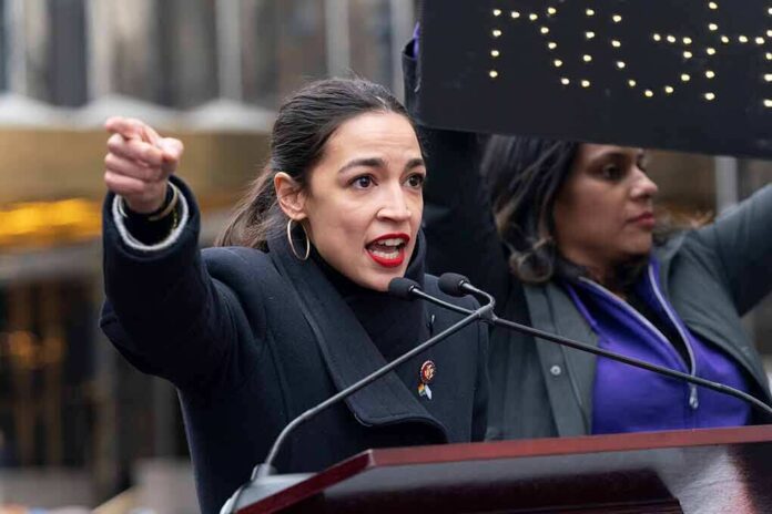 AOC speaking passionately at outdoor event.