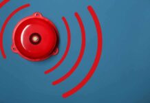 Red alarm bell on a blue background