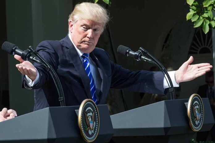 1456093781 featured image Trump behind podium with microphones