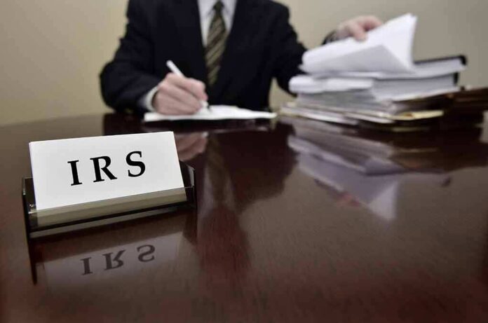 158874281 featured image IRS sign on desk with person working