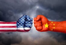 Two fists painted with USA and China flags