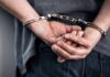 Person in handcuffs with hands behind back