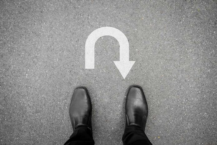 332468855 featured image Feet in black shoes facing U-turn road marking