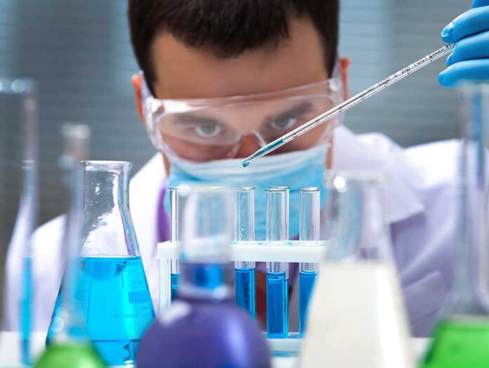 125266409 featured image Scientist pipetting blue liquid into test tubes