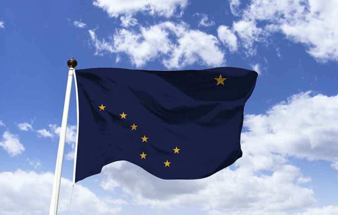 1363238492 featured image Alaska state flag flying against a blue sky