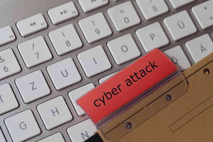 Keyboard with red folder labeled cyber attack