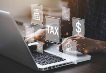 Person typing on laptop with tax-related icons displayed