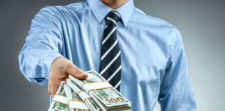 Person handing over a stack of money