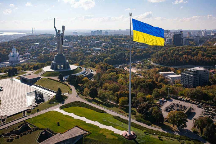 2057020673 Large Ukraine flag with cityscape in background