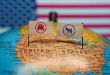 Republican and Democratic flags on USA map background.