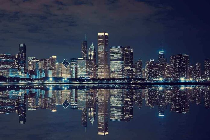 Nighttime view of a city skyline with reflections on water