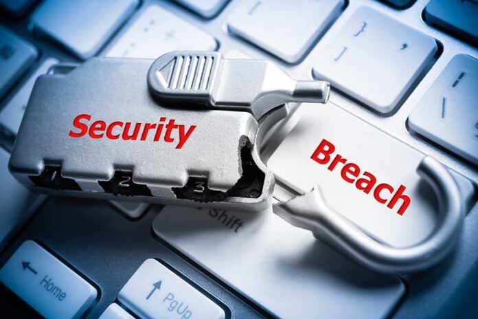 A padlock with the words Security and Breach on a computer keyboard