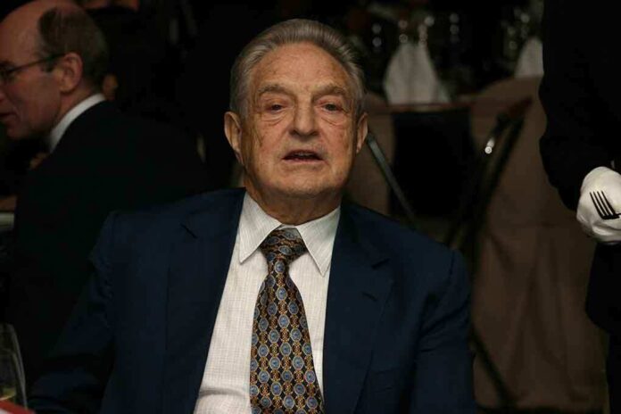 Elderly man in a suit sitting at a dining table during a formal event