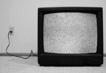 A vintage television displaying static on the screen