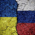Trump’s Ukraine Reversal SHOCKS Policy Experts Cracked Ukrainian and Russian flags painted on concrete