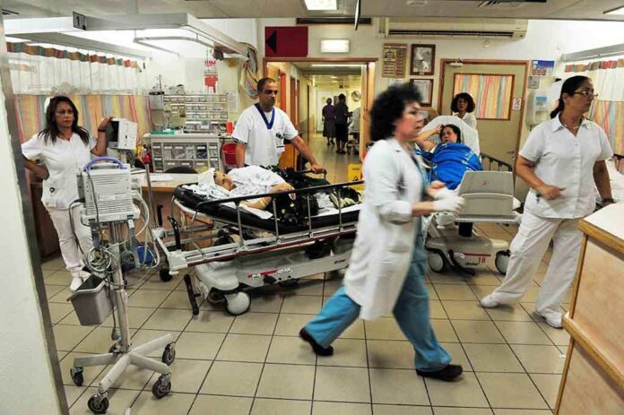 Medical staff attending to patients in a busy hospital emergency room
