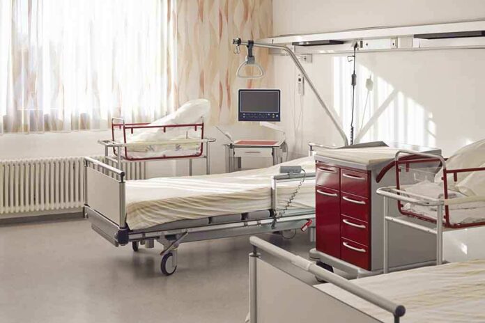 A hospital room featuring empty patient beds and medical equipment