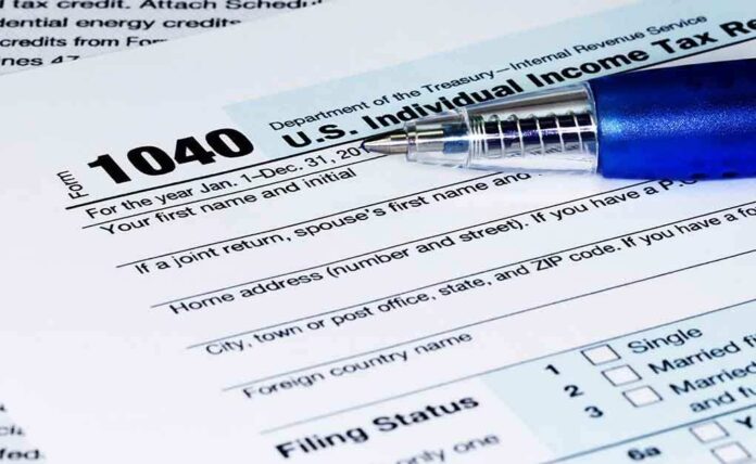 close up of us Individual Income Tax Return form 1040 with a pen
