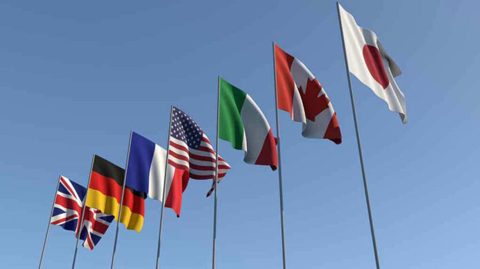 1437085796 Flags of seven countries against clear blue sky