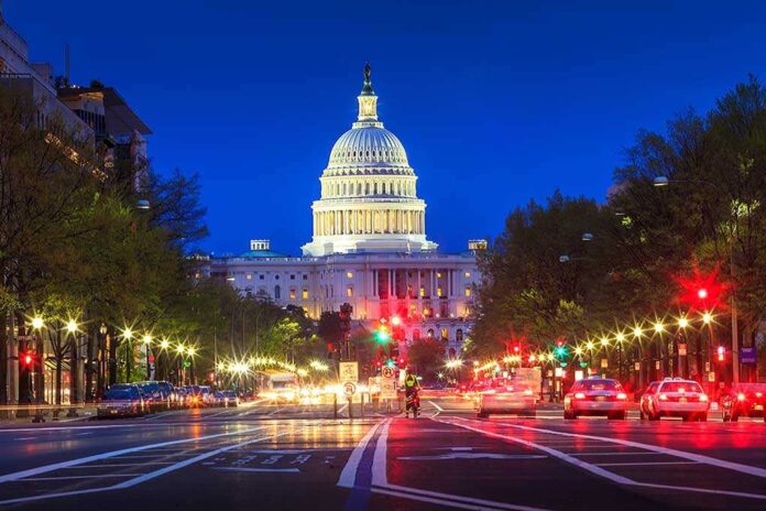 shutterstock_174209186.jpg The US Capitol building illuminated at night with city traffic in the foreground