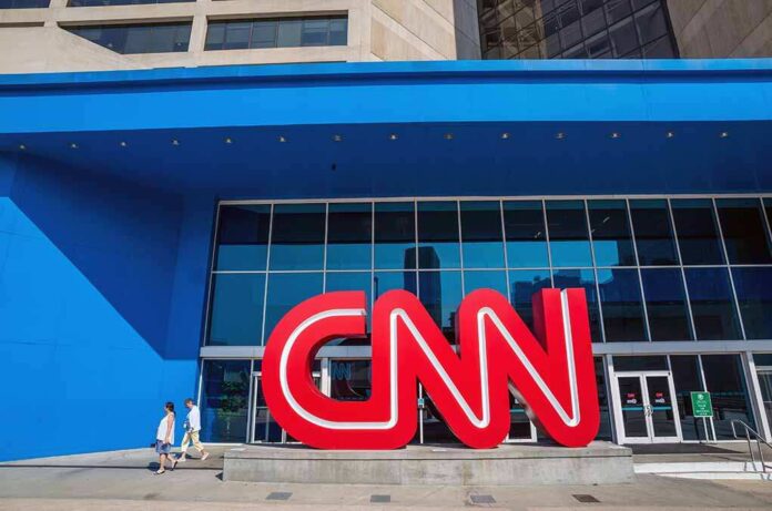 shutterstock_209605063.jpg Exterior view of the CNN building with a large red logo and blue facade