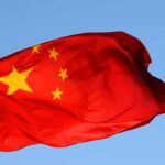 China’s SHOCKING Aircraft Test: U.S. Defense Alerted Chinese flag waving against a clear blue sky