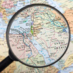 Qatar’s $29 Billion Power Play Shocks Egypt Magnifying glass over Middle East map highlighting Israel and Egypt