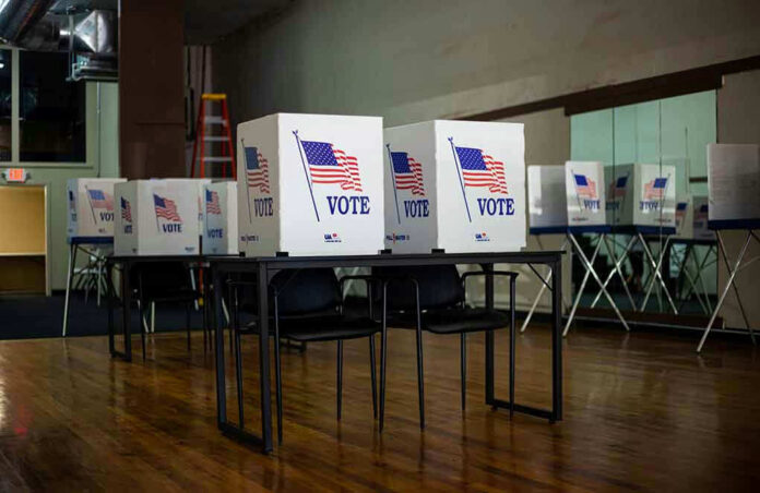 1837302946 Voting booths set up in a room