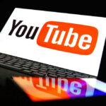 Lazy AI Trick: College Dropout RAKES IN $700K YouTube logo on a laptop and smartphone screen.