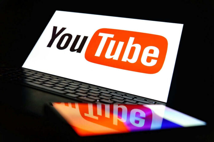 YouTube logo on a laptop and smartphone screen.