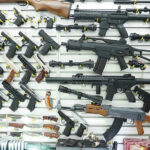Is New Mexico Killing the Second Amendment With New Bill? Wall display of various firearms in a store.