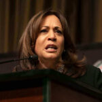 NYC Mayor Torches Kamala Harris Over Maduro Flip Woman speaking at a podium on stage.