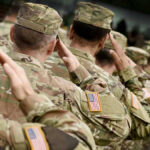 Unprecedented Defense Move: $1.5 Trillion Proposal Soldiers in camouflage uniforms saluting in formation outdoors