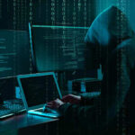 Whistleblower Exposes 4,500 ICE Agents—National Security at Risk Hacker in dark room surrounded by computer screens.