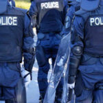 ICE Shooting Sparks George Floyd Comparisons Police officers in riot gear with shields.
