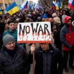 Americans’ War Enthusiasm Plummets Crowd of protesters holding a sign that says NO WAR during a demonstration