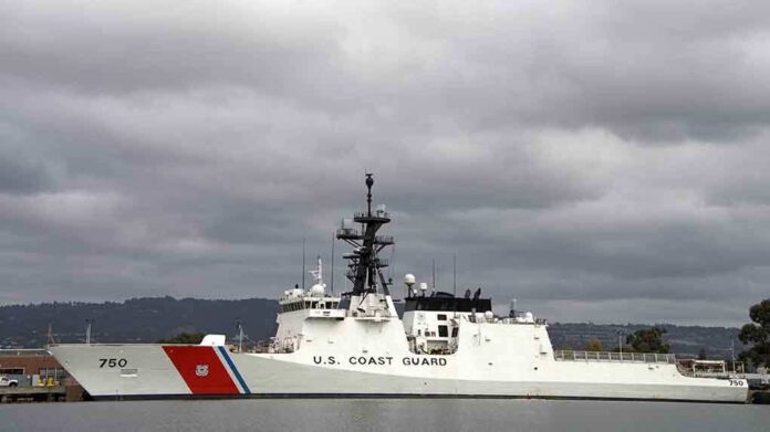 A U.S. Coast Guard ship docked under cloudy skies