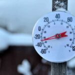 Outdoor thermometer displaying a very low temperature in a snowy setting