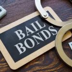 Teen’s Bonfire Death Sparks Outrage: Shooter Walks Free A bail bonds sign with handcuffs and stacks of cash