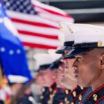 Ex-Marine’s Early Release Sparks New Arrest U.S. Marines in uniform standing in formation with flags in the background