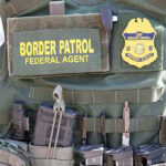 $100 Million ICE Wartime Recruitment Blitz Border Patrol vest with gear and communication equipment.
