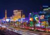 Vibrant view of the Las Vegas Strip at night with neon lights and traffic