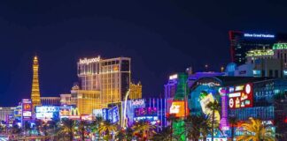 Vibrant view of the Las Vegas Strip at night with neon lights and traffic