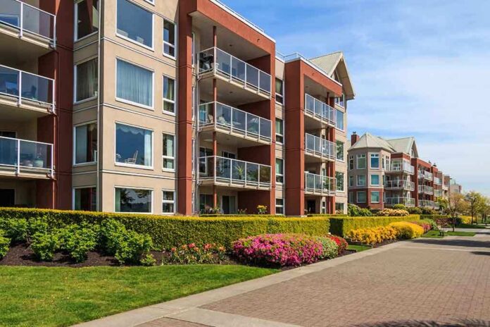 Modern apartment buildings with balconies and landscaped gardens on a sunny day
